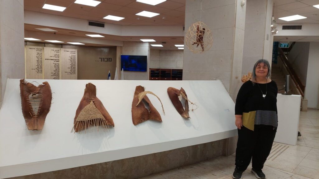 Yaffe Ozeri next to her work "Missing Heart" at the exhibition